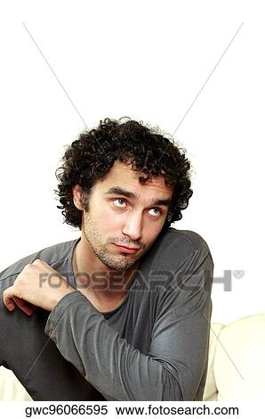 Close-up of a young man looking away View Large Photo Image Stock Photography - Close-up of a young man looking away. Fotosearch