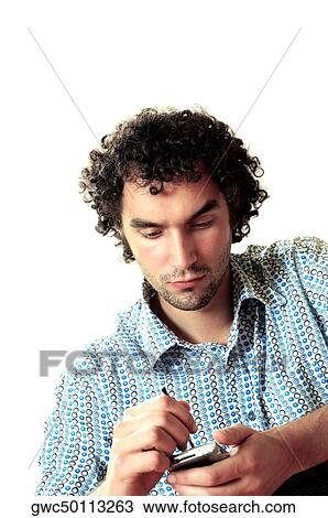 Stock Image - Close-up of a young man operating a personal data assistant. Fotosearch
