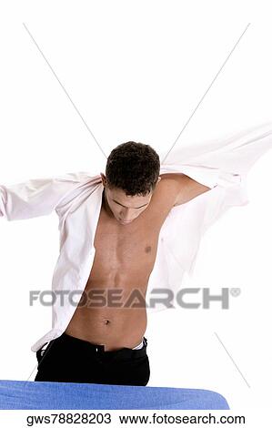 Close-up of a young man putting on his shirt View Large Photo Image Stock Image - Close-up of a young man putting on his shirt. Fotosearch