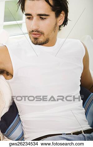 Close-up of a young man sitting View Large Photo Image Picture - Close-up of a young man sitting. Fotosearch