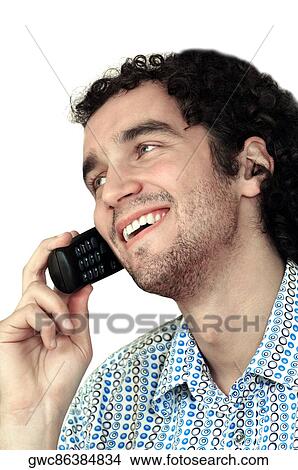 Close-up of a young man talking on a mobile phone View Large Photo Image Picture - Close-up of a young man talking on a mobile phone. Fotosearch