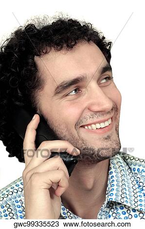Close-up of a young man talking on a mobile phone View Large Photo Image Stock Image - Close-up of a young man talking on a mobile phone. Fotosearch