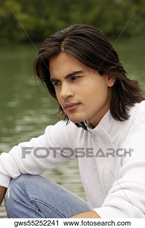 Stock Image - Close-up of a young man thinking. Fotosearch