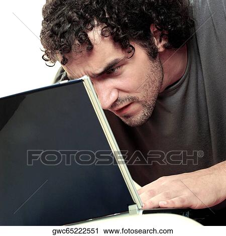 Close-up of a young man using a laptop View Large Photo Image Stock Image - Close-up of a young man using a laptop. Fotosearch