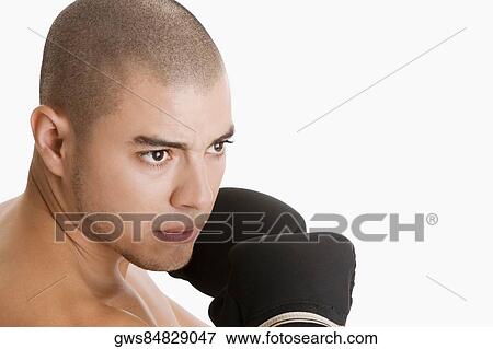 Close-up of a young man wearing boxing gloves View Large Photo Image Stock Photo - Close-up of a young man wearing boxing gloves. Fotosearch