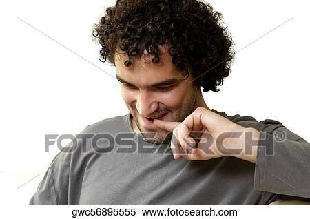 Stock Photography - Close-up of a young man with his finger on his lips. Fotosearch