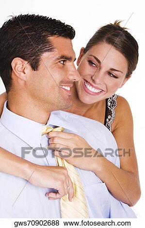 Close-up of a young woman adjusting a mid adult man's tie View Large Photo Image Stock Photo - Close-up of a young woman adjusting a mid adult man's tie. Fotosearch