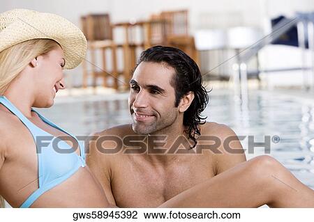 Close-up of a young woman and a mid adult man looking at each other View Large Photo Image Stock Image - Close-up of a young woman and a mid adult man looking at each other. Fotosearch