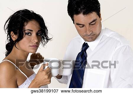 Close-up of a young woman and a mid adult man holding coffee cups View Large Photo Image Stock Photo - Close-up of a young woman and a mid adult man holding coffee cups. Fotosearch