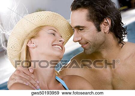 Close-up of a young woman and a mid adult man looking at each other View Large Photo Image Stock Photo - Close-up of a young woman and a mid adult man looking at each other. Fotosearch