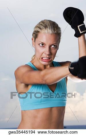 Close-up of a young woman boxing View Large Photo Image Picture - Close-up of a young woman boxing. Fotosearch