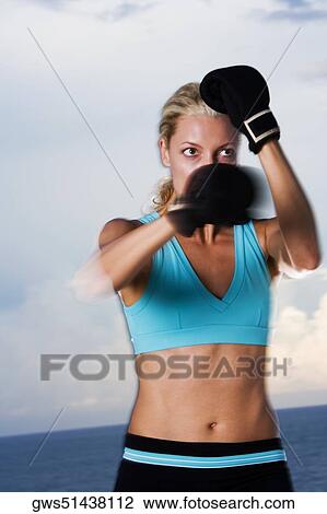 Stock Image - Close-up of a young woman boxing. Fotosearch