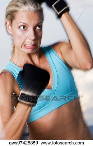 Close-up of a young woman boxing View Large Photo Image Stock Photo - Close-up of a young woman boxing. Fotosearch