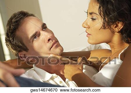 Close-up of a young woman consoling a young man View Large Photo Image Stock Image - Close-up of a young woman consoling a young man. Fotosearch