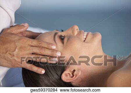 Close-up of a young woman getting a head massage View Large Photo Image Picture - Close-up of a young woman getting a head massage. Fotosearch