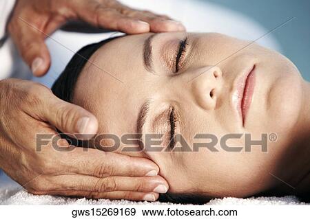 Close-up of a young woman getting a head massage View Large Photo Image Stock Photo - Close-up of a young woman getting a head massage. Fotosearch