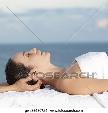 Close-up of a young woman getting a head massage View Large Photo Image Stock Photography - Close-up of a young woman getting a head massage. Fotosearch