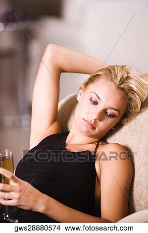 Close-up of a young woman holding a glass of wine View Large Photo Image Picture - Close-up of a young woman holding a glass of wine. Fotosearch