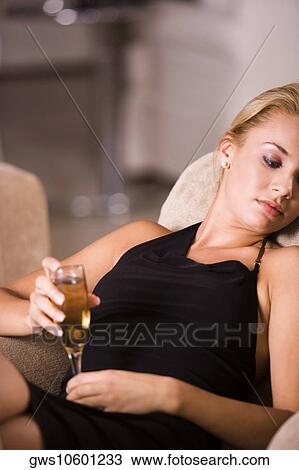 Close-up of a young woman holding a glass of wine View Large Photo Image Stock Image - Close-up of a young woman holding a glass of wine. Fotosearch