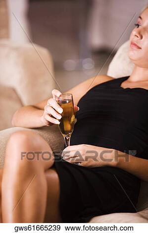 Stock Photo - Close-up of a young woman holding a glass of wine. Fotosearch