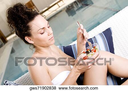 Close-up of a young woman holding a bowl of salad View Large Photo Image Stock Photo - Close-up of a young woman holding a bowl of salad. Fotosearch