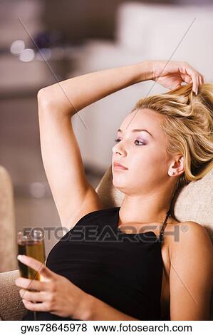 Close-up of a young woman holding a glass of wine View Large Photo Image Stock Photo - Close-up of a young woman holding a glass of wine. Fotosearch
