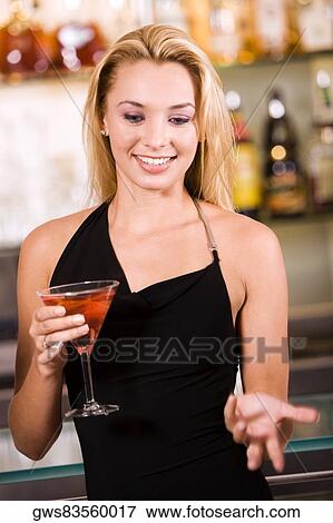 Close-up of a young woman holding a glass of wine View Large Photo Image Stock Photo - Close-up of a young woman holding a glass of wine. Fotosearch