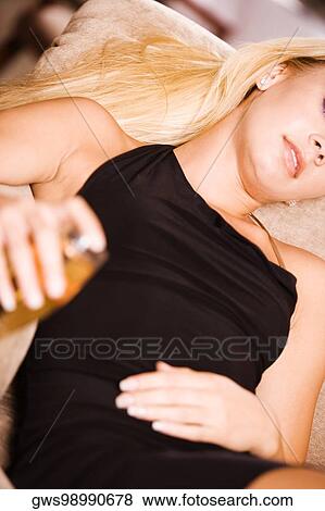 Close-up of a young woman holding a glass of wine View Large Photo Image Stock Photo - Close-up of a young woman holding a glass of wine. Fotosearch