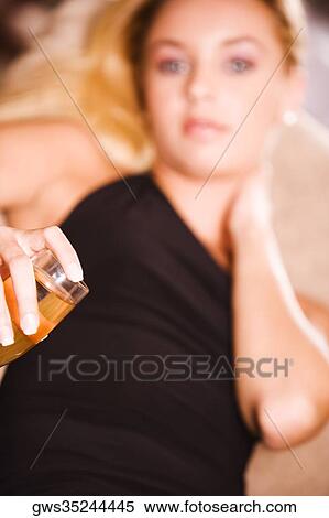 Close-up of a young woman holding a glass of wine View Large Photo Image Stock Photography - Close-up of a young woman holding a glass of wine. Fotosearch