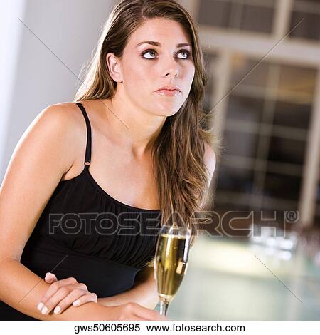 Close-up of a young woman holding a champagne flute View Large Photo Image Stock Photography - Close-up of a young woman holding a champagne flute. Fotosearch