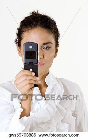 Close-up of a young woman looking at a mobile phone View Large Photo Image Stock Photograph - Close-up of a young woman looking at a mobile phone. Fotosearch