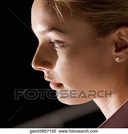 Close-up of a young woman looking away View Large Photo Image Stock Image - Close-up of a young woman looking away. Fotosearch