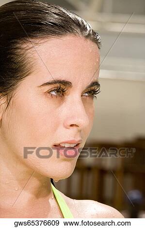 Close-up of a young woman looking away View Large Photo Image Stock Photo - Close-up of a young woman looking away. Fotosearch