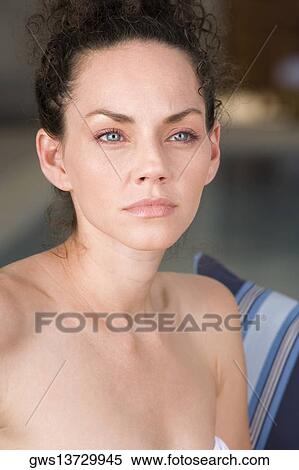 Close-up of a young woman looking away View Large Photo Image Stock Photography - Close-up of a young woman looking away. Fotosearch