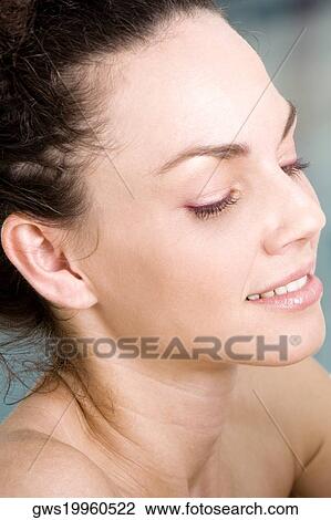 Close-up of a young woman looking down View Large Photo Image Stock Image - Close-up of a young woman looking down. Fotosearch