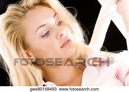 Stock Image - Close-up of a young woman looking down. Fotosearch