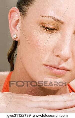 Stock Photo - Close-up of a young woman looking down. Fotosearch