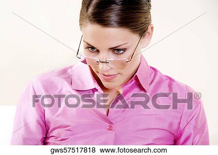 Close-up of a young woman looking down View Large Photo Image Stock Photo - Close-up of a young woman looking down. Fotosearch