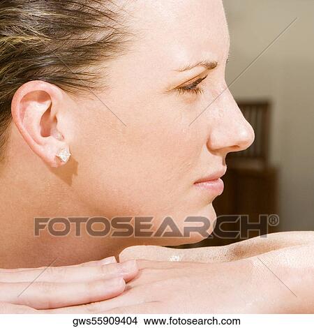 Close-up of a young woman looking sideways View Large Photo Image Picture - Close-up of a young woman looking sideways. Fotosearch