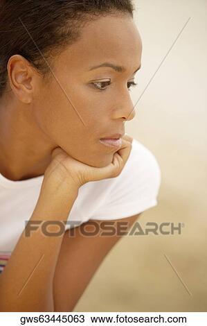 Close-up of a young woman looking sad View Large Photo Image Stock Image - Close-up of a young woman looking sad. Fotosearch