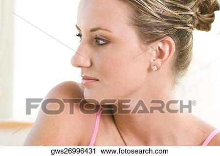 Close-up of a young woman looking sideways View Large Photo Image Stock Image - Close-up of a young woman looking sideways. Fotosearch