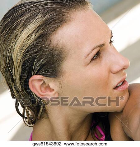 Close-up of a young woman looking sideways View Large Photo Image Stock Image - Close-up of a young woman looking sideways. Fotosearch
