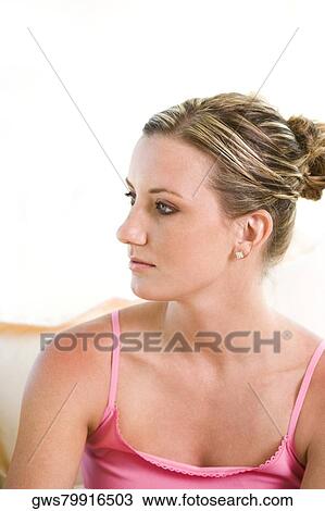 Close-up of a young woman looking sideways View Large Photo Image Stock Image - Close-up of a young woman looking sideways. Fotosearch