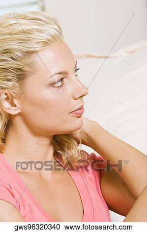Close-up of a young woman looking sideways View Large Photo Image Stock Image - Close-up of a young woman looking sideways. Fotosearch