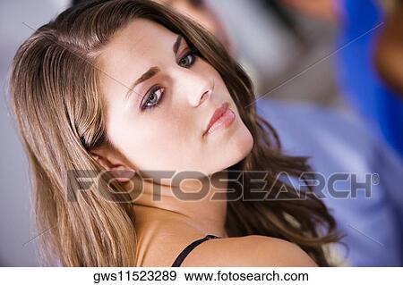 Close-up of a young woman looking serious View Large Photo Image Stock Photo - Close-up of a young woman looking serious. Fotosearch