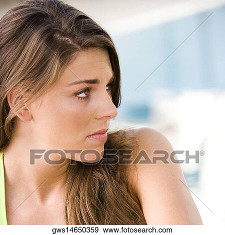 Close-up of a young woman looking sideways View Large Photo Image Stock Photo - Close-up of a young woman looking sideways. Fotosearch