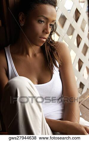 Stock Photo - Close-up of a young woman looking pensive. Fotosearch