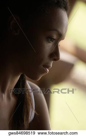 Close-up of a young woman looking serious View Large Photo Image Stock Photo - Close-up of a young woman looking serious. Fotosearch