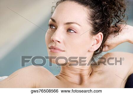 Close-up of a young woman looking sideways View Large Photo Image Stock Photograph - Close-up of a young woman looking sideways. Fotosearch