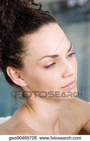 Close-up of a young woman looking serious View Large Photo Image Stock Photograph - Close-up of a young woman looking serious. Fotosearch